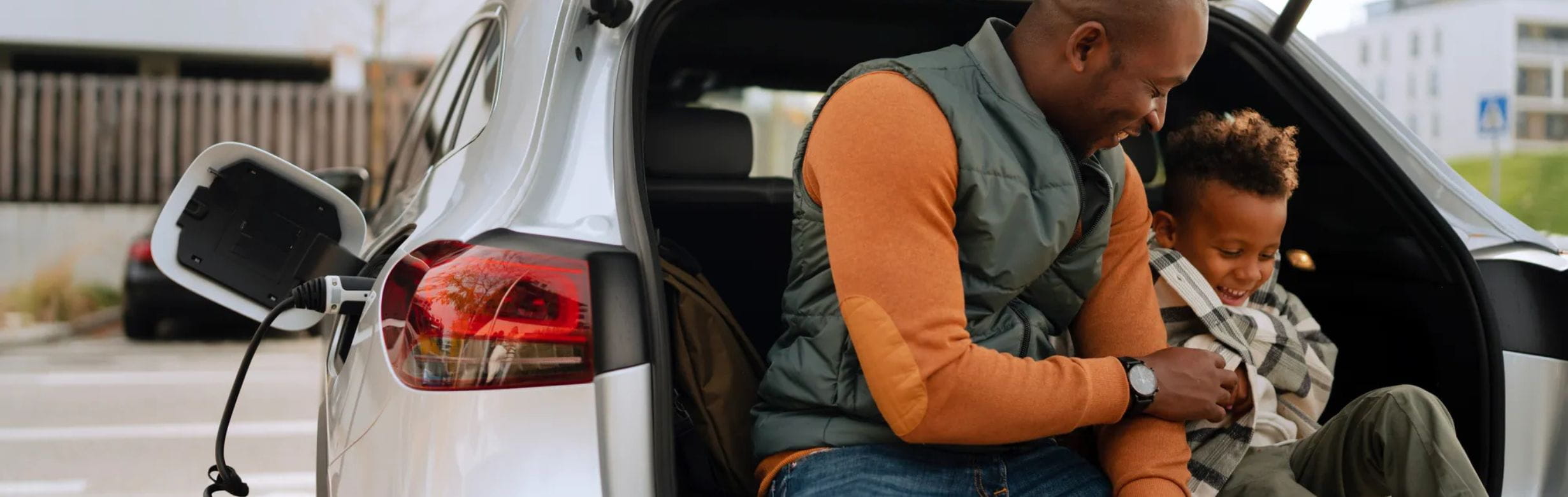 Car charging with people sitting in trunk