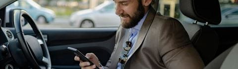 Man checking phone in car